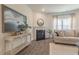 Cozy living room with a fireplace, large windows, and a comfortable sofa with pillows at 259 Eason St, Bowdon, GA 30108