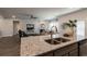 An open-concept living room features a fireplace and a view of the granite countertop island at 259 Eason St, Bowdon, GA 30108