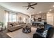 Bright living space featuring an open floor plan and hardwood floors leading to the kitchen at 259 Eason St, Bowdon, GA 30108