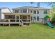 Large backyard with a spacious screened porch and a playset in the green lawn at 2823 Seagrave Way, Marietta, GA 30066
