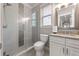 Beautiful bathroom featuring a glass-enclosed shower and a vanity with a stylish mirror at 2823 Seagrave Way, Marietta, GA 30066