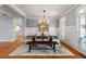 Elegant dining room with a stylish chandelier, hardwood floors, and large windows at 2823 Seagrave Way, Marietta, GA 30066