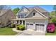 Traditional two-story home featuring a manicured lawn, attached two-car garage, and neutral-colored siding at 2823 Seagrave Way, Marietta, GA 30066