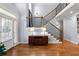 Inviting foyer featuring hardwood floors, staircase with iron spindles, and a decorative console table with lamps at 2823 Seagrave Way, Marietta, GA 30066