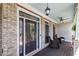 Inviting front porch with comfortable seating, brick accents, and a ceiling fan for relaxing outdoors at 2823 Seagrave Way, Marietta, GA 30066