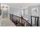 Upstairs hallway showcasing decorative lighting and wrought iron railings at 2823 Seagrave Way, Marietta, GA 30066
