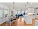 Open-concept kitchen and dining area with hardwood floors, white cabinets, and stainless-steel appliances at 2823 Seagrave Way, Marietta, GA 30066
