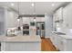 Modern kitchen with white cabinets, granite countertops, stainless steel appliances, and tile backsplash at 2823 Seagrave Way, Marietta, GA 30066