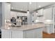Bright kitchen with white cabinets, stainless steel appliances, granite countertops and hardwood floors at 2823 Seagrave Way, Marietta, GA 30066