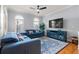 Comfortable living room featuring a blue sectional sofa, modern TV console, and stylish rug at 2823 Seagrave Way, Marietta, GA 30066
