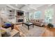 Inviting living room with stone fireplace, built-in shelving, hardwood floors and abundant natural light at 2823 Seagrave Way, Marietta, GA 30066