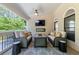 Inviting covered patio with comfortable seating, a fireplace, ceiling fan, and outdoor TV at 2823 Seagrave Way, Marietta, GA 30066