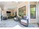 Relaxing covered patio with wicker furniture, an outdoor TV and arched windows at 2823 Seagrave Way, Marietta, GA 30066