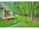 Expansive backyard showcasing a hot tub, lush lawn, and surrounding trees at 2010 Univeter Rd, Canton, GA 30115