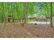Beautiful treed backyard with a basketball court, and fire pit at 2010 Univeter Rd, Canton, GA 30115