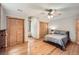 Cozy bedroom featuring hardwood floors, built in closets, and natural light from the window at 2010 Univeter Rd, Canton, GA 30115