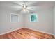 Bright, cozy bedroom with hardwood floors and natural light from two windows at 2010 Univeter Rd, Canton, GA 30115