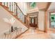 Welcoming foyer with hardwood floors, staircase, and a decorative glass front door at 2010 Univeter Rd, Canton, GA 30115