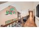 Open hallway with wooden floors, iron railings, natural light, and a view of the living room below at 2010 Univeter Rd, Canton, GA 30115