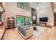 Bright living room featuring a floor-to-ceiling stone fireplace and scenic backyard views at 2010 Univeter Rd, Canton, GA 30115