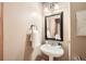 Charming powder room with pedestal sink, decorative mirror, and neutral wall color at 2010 Univeter Rd, Canton, GA 30115