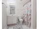 Bathroom featuring a shower-tub combo, vanity with sink, and elegant marble-like floors at 2620 Nesbitt Crossing Way, Duluth, GA 30096