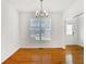 Dining room with hardwood floors, a modern chandelier, and ample natural light at 2620 Nesbitt Crossing Way, Duluth, GA 30096