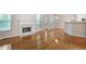 Open living room with fireplace, hardwood floors, and views to the kitchen area at 2620 Nesbitt Crossing Way, Duluth, GA 30096