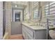 Elegant bathroom featuring granite countertops, neutral tile flooring, and bright natural light from shuttered windows at 452 Cherokee Ne St, Marietta, GA 30060