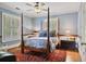 Beautiful bedroom with hardwood floors, a ceiling fan, shuttered windows, a 4-poster bed, and an antique rug at 452 Cherokee Ne St, Marietta, GA 30060