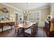 Charming dining room featuring wood table, patterned rug, and natural light from shuttered windows at 452 Cherokee Ne St, Marietta, GA 30060
