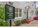 Charming exterior detail displaying the property's historical significance with a distinguished sign and manicured landscaping at 452 Cherokee Ne St, Marietta, GA 30060