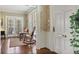 Inviting foyer with a view of the living room with hardwood floors, rocking chairs and large shuttered windows at 452 Cherokee Ne St, Marietta, GA 30060