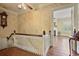 Upstairs hallway with hardwood floors leads to a bright living room, showcasing classic millwork and natural light at 452 Cherokee Ne St, Marietta, GA 30060