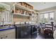 A charming laundry room with modern washer and dryer, sink and blue countertops, storage shelves, and a window view at 452 Cherokee Ne St, Marietta, GA 30060