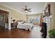 Large main bedroom with hardwood floors, fireplace, natural light, a ceiling fan, and adjacent bathroom at 452 Cherokee Ne St, Marietta, GA 30060