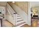 Elegant staircase featuring wood steps, white risers, and decorative wallpaper, leading to the upper level at 452 Cherokee Ne St, Marietta, GA 30060