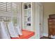 This bright window seat features white shuttered windows, and custom shelving, bringing a cozy reading nook to life at 452 Cherokee Ne St, Marietta, GA 30060