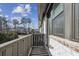 This balcony features a wooden railing, brick facade, and a view of the neighborhood at 6442 Canopy Dr, Sandy Springs, GA 30328
