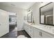 Bright bathroom featuring double sinks, a large mirror, white cabinets, and a tiled floor at 6442 Canopy Dr, Sandy Springs, GA 30328