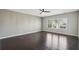Spacious bedroom featuring hardwood floors, a ceiling fan, and bright natural light from large windows at 6442 Canopy Dr, Sandy Springs, GA 30328
