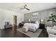Well-appointed bedroom featuring neutral paint, plush bedding, hardwood floors and modern ceiling fan at 6442 Canopy Dr, Sandy Springs, GA 30328