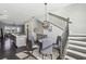 Dining area with modern chandelier, staircase, adjacent island counter, and living area at 6442 Canopy Dr, Sandy Springs, GA 30328