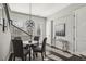Dining area with modern chandelier, adjacent stairs, and rear entry with decor art on wall at 6442 Canopy Dr, Sandy Springs, GA 30328