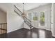 Dining area with staircase, a modern chandelier, and a rear entry door at 6442 Canopy Dr, Sandy Springs, GA 30328
