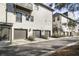 Condo garages with dark doors and matching wall lanterns at 6442 Canopy Dr, Sandy Springs, GA 30328