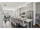 Spacious kitchen features gray cabinets, stainless appliances, and a central island with marble countertop at 6442 Canopy Dr, Sandy Springs, GA 30328