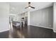 Spacious living room with dark wood floors and open to kitchen featuring stainless appliances and island at 6442 Canopy Dr, Sandy Springs, GA 30328