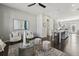 Open-concept living room with contemporary furniture, a modern ceiling fan and view of kitchen and dining at 6442 Canopy Dr, Sandy Springs, GA 30328