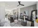 Open-concept living room featuring a modern ceiling fan, neutral furniture, and view of the kitchen at 6442 Canopy Dr, Sandy Springs, GA 30328